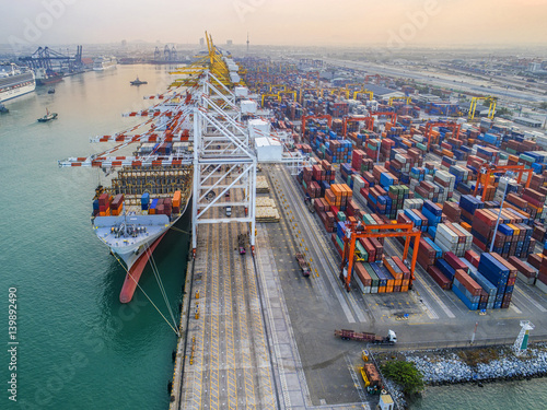 commercial vessel container ship alongside of berth in port congestion for loading and discharging  containers services in maritime transports in World wide logistics photo