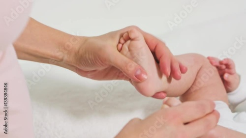Wallpaper Mural mother massaging little baby's feet with oil Torontodigital.ca