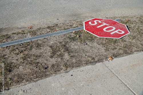 stop sign fallen on the road side