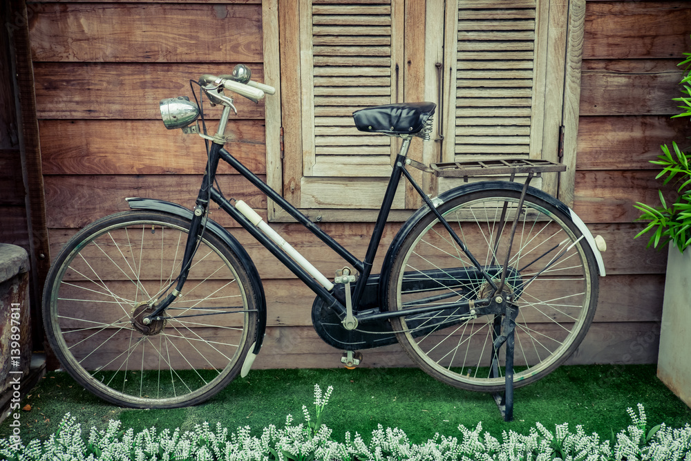 Old bicycle on vintage wooden floor
