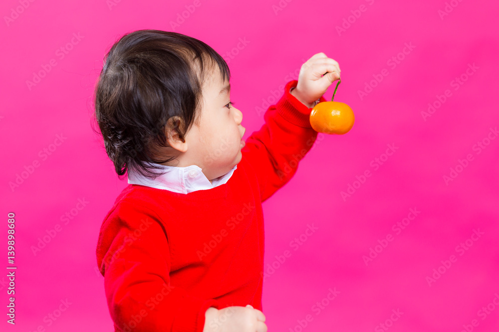 Chinese little baby looking at citrus Chinese little baby looking at citrus