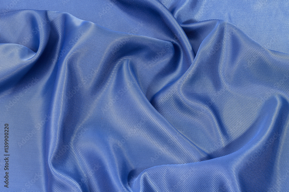 Fototapeta premium Silk background, texture of blue shiny fabric, close up