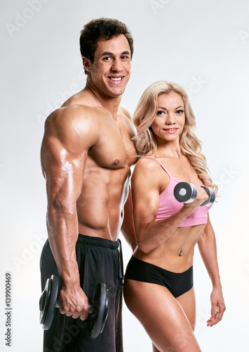 Sporty couple with dumbbells