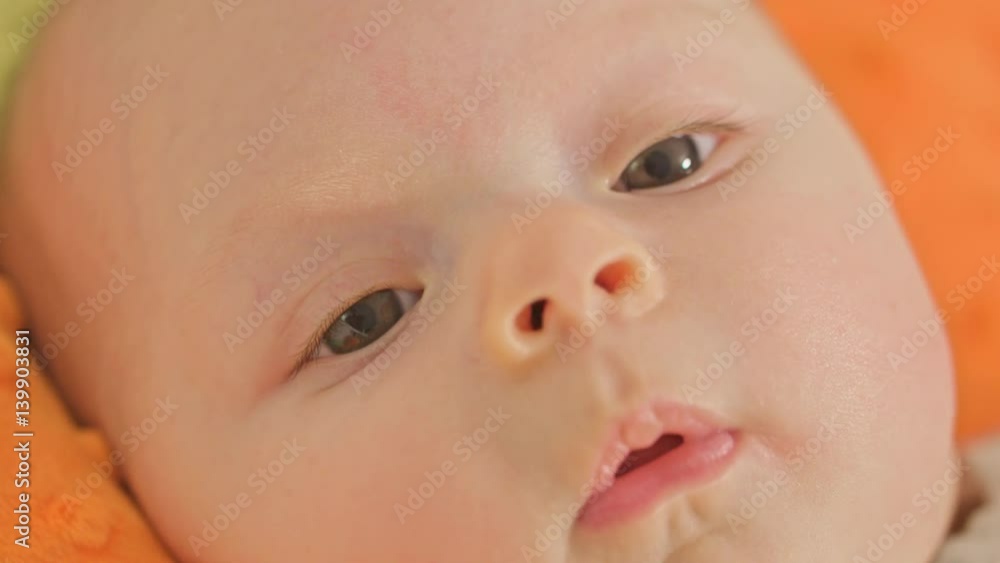 Sweet baby is lying on a back close up Sweet baby is lying on a back close up