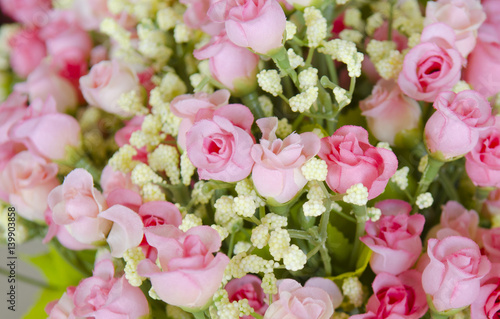 wedding bouquet with rose bush  Ranunculus asiaticus as a background