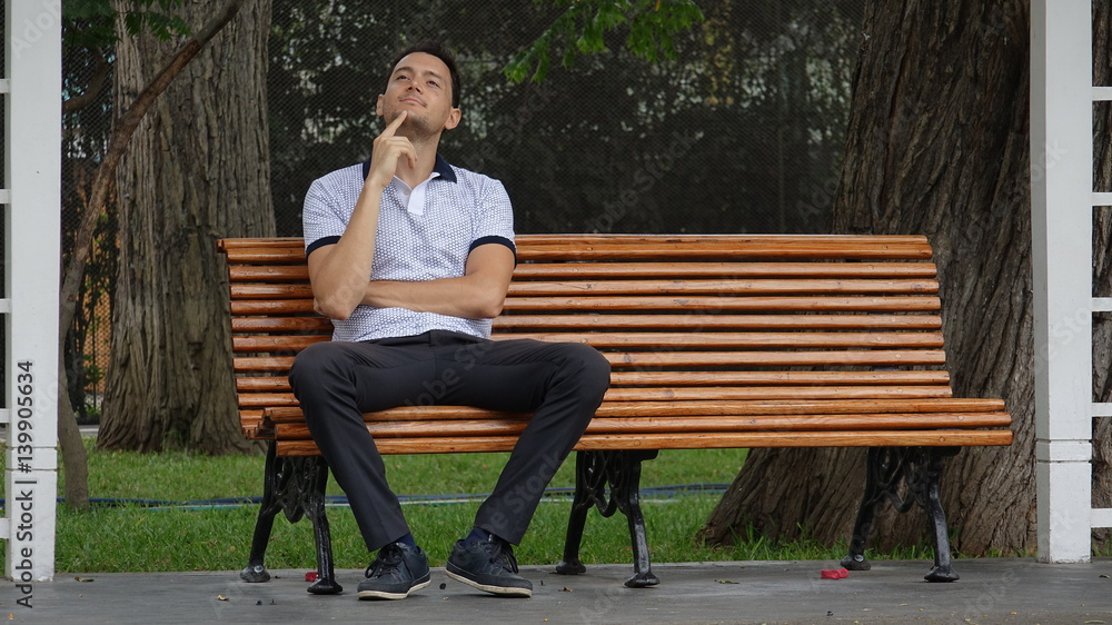 Fototapeta premium Man Sitting Alone In Park And Daydreaming