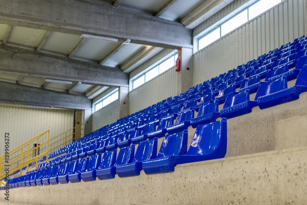 Fototapeta premium rows of blue chairs on the podium of the sports hall