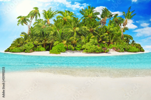 Whole tropical island within atoll in tropical Ocean and inscription  Vacations  in the sand on a tropical island.