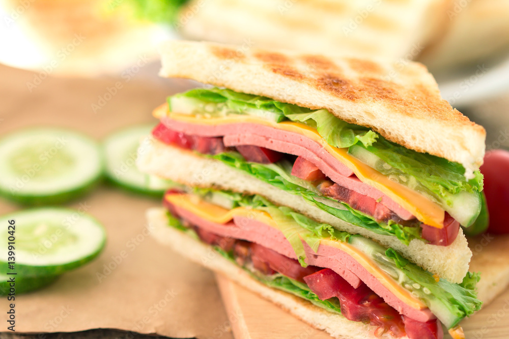 Sliced Grilled sandwiches bread with bacon , ham and cheese with vegetable , healthy breakfast Sliced Grilled sandwiches bread with bacon , ham and cheese with vegetable , healthy breakfast