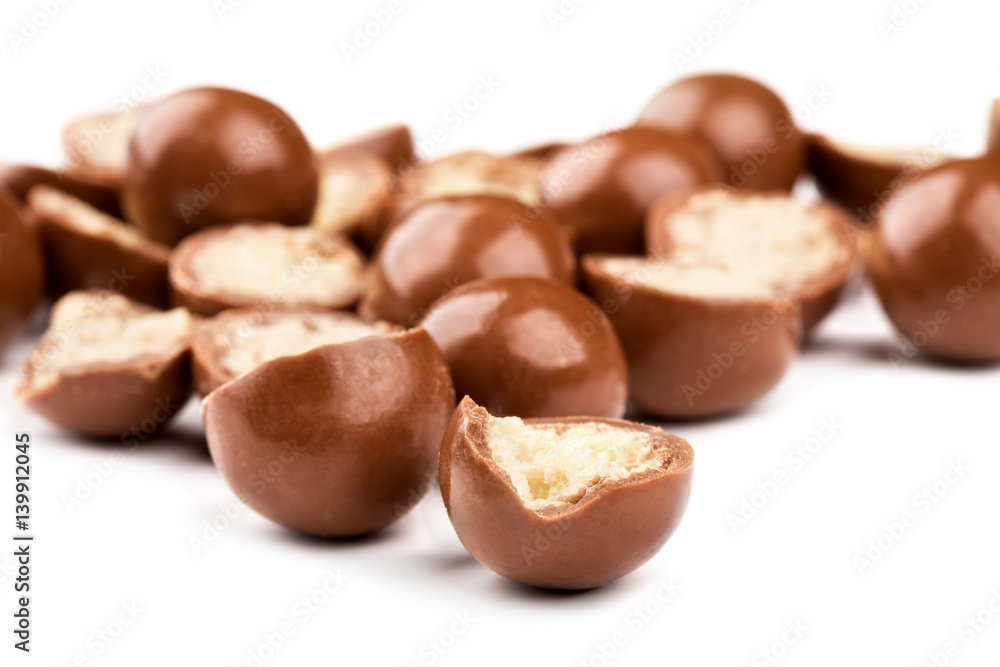 Chocolate balls and halves with crisp filling isolated on white Chocolate balls and halves with crisp filling isolated on white