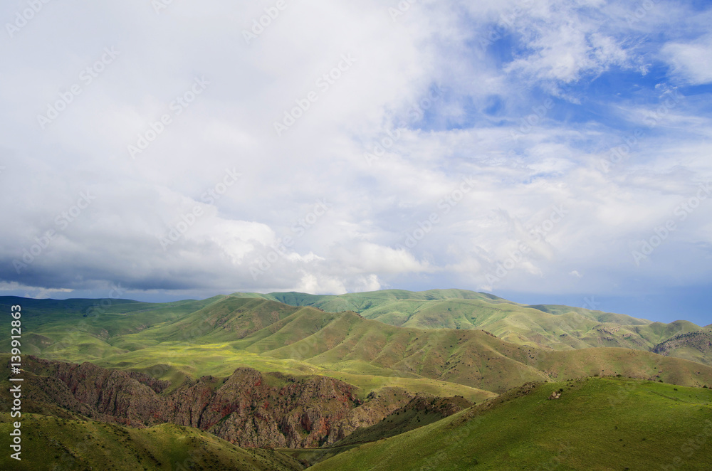 Beautiful landscape with green mountains and magnificent cloudy sky. Beautiful landscape with green mountains and magnificent cloudy sky.