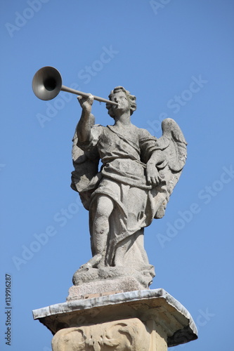 Statue of angel playing the horn