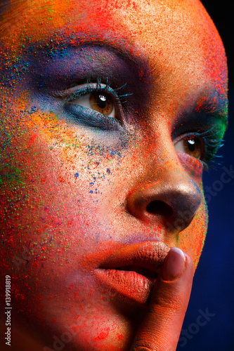 Model with art make-up posi...