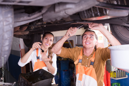 Two mechanics repairing car © JackF