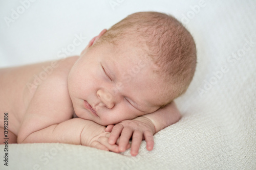 Charming newborn girl sleeping stomach,lifestyle