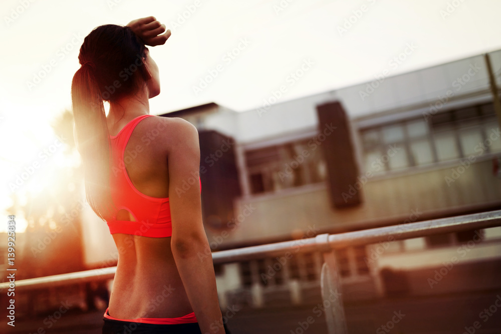 Beautiful female jogger doing her run in sunset Beautiful female jogger doing her run in sunset