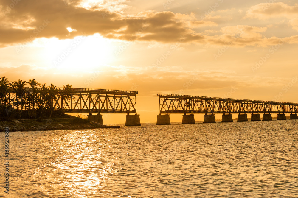 Remains of Bahia Honda railroad bridge in Florida Keys at sunset

