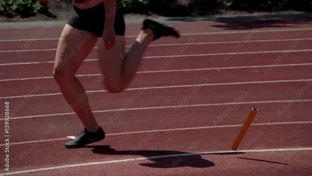 Woman relay racer dropping the baton, switch from real-time to slow ...