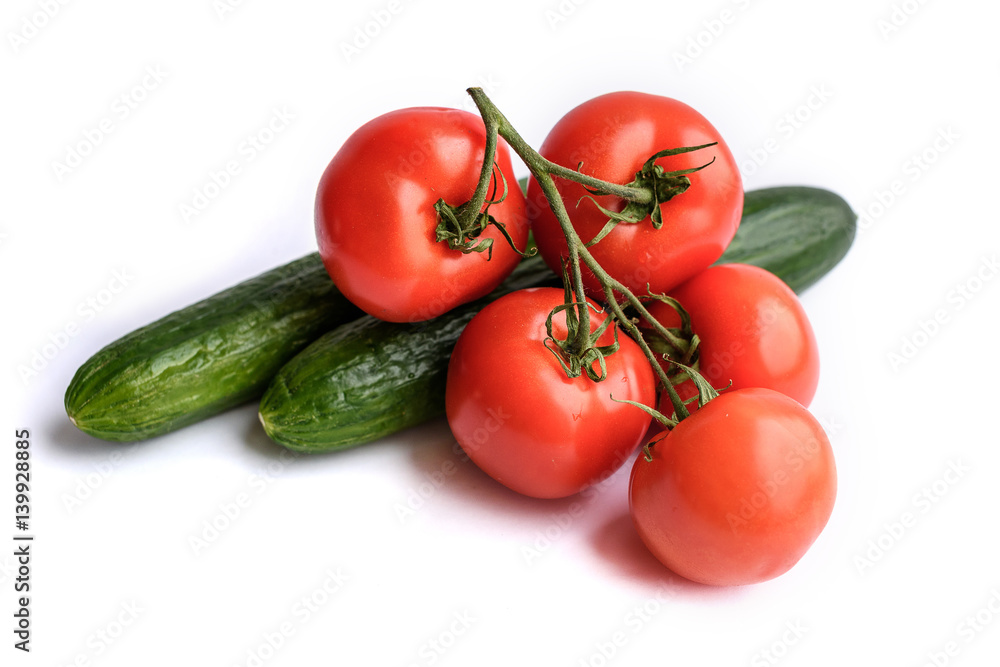 Isolated salad ingredients. Fresh vegetables (tomato and cucumber ) isolated on white background Isolated salad ingredients. Fresh vegetables (tomato and cucumber ) isolated on white background