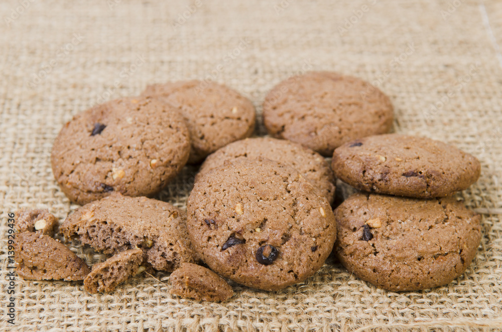 Stacked chocolate chip cookies on brown napkin Stacked chocolate chip cookies on brown napkin