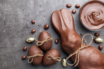 Chocolate Easter bunny and eggs on wooden background