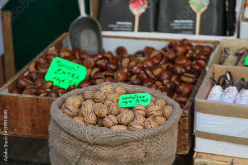 walnuts in street market and marroni photo