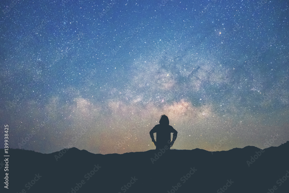 Long exposure Man standing along the waters edge under the Milky Way galaxy Long exposure Man standing along the waters edge under the Milky Way galaxy