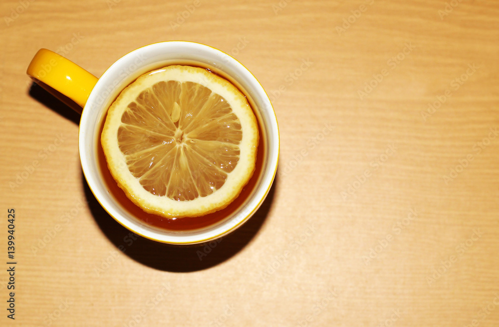 Yellow tea cup and lemon, hot drink Yellow tea cup and lemon, hot drink