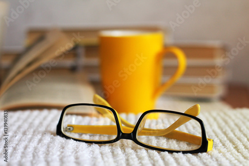 Bright yellow cup of tea and beautiful glasses