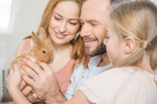 Happy family with rabbit © LIGHTFIELD STUDIOS