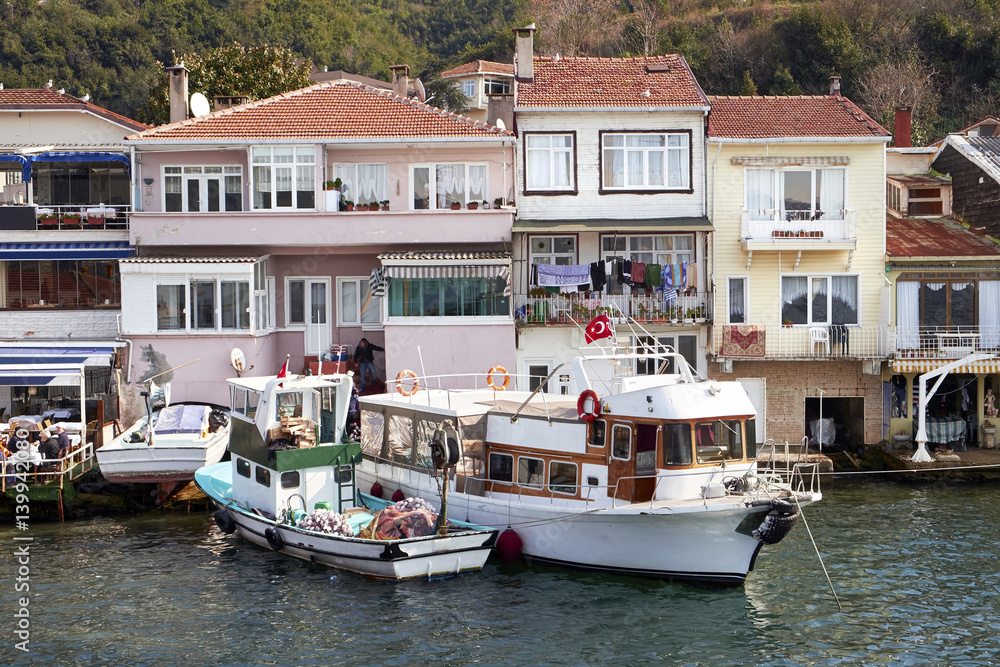 Turkish homes and boats on the Bosporus Strait, Istanbul in Turkey.