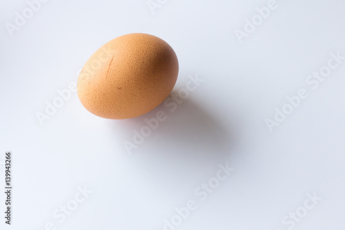Brown egg on white background