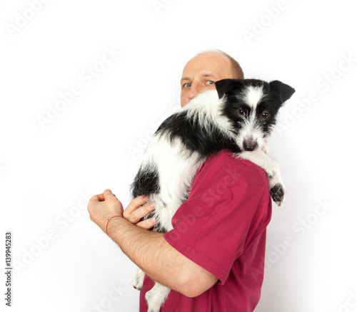 Veterinary doctor holds a small mongrel dog © annatronova