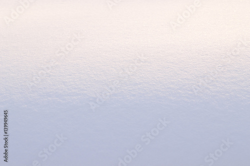 Snowy terrain with gradient illumination.
Background. Snowy surface in the form of a roller.