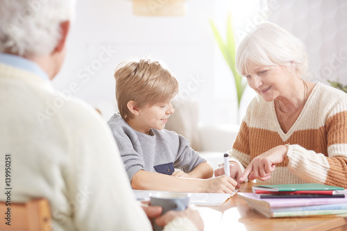 Boy doing homework with grandma