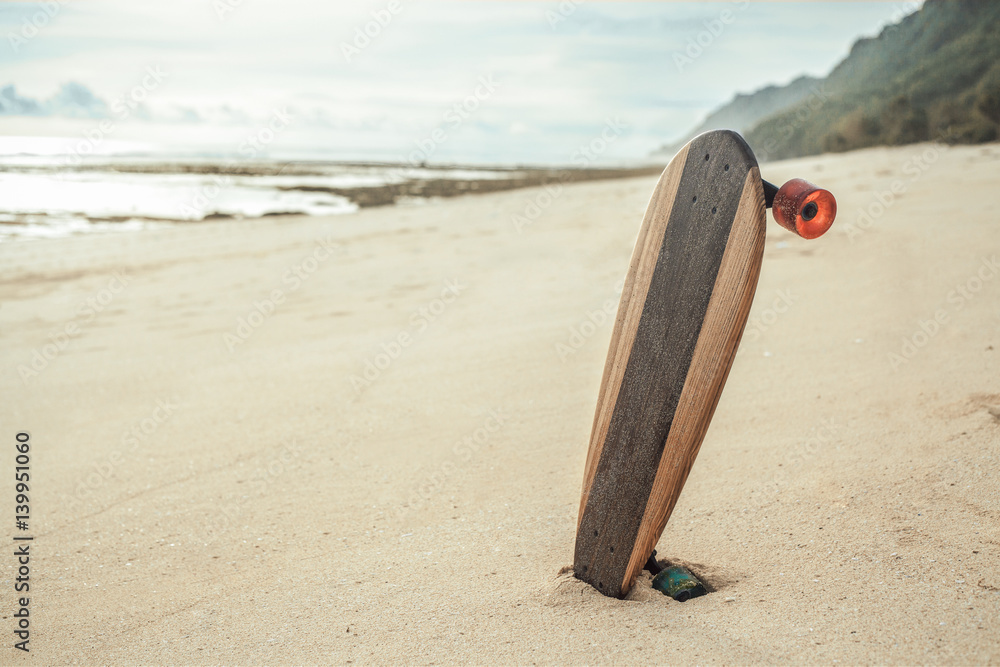 skateboard on the beach at sunset, youth and freedom concept skateboard on the beach at sunset, youth and freedom concept