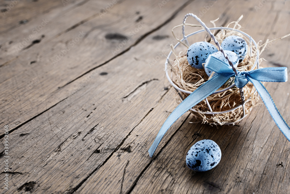 Easter basket with colored easter eggs on old rustic wooden table.free text space. Selective focus. Easter basket with colored easter eggs on old rustic wooden table.free text space. Selective focus.