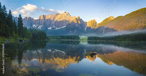 sunrise over the crystal-clear mountain lake in the Julian Alps