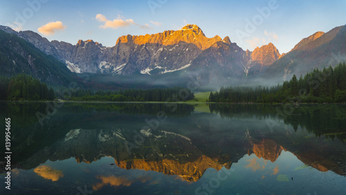 Fototapeta Naklejka Na Ścianę i Meble -  sunrise over the crystal-clear mountain lake in the Julian Alps