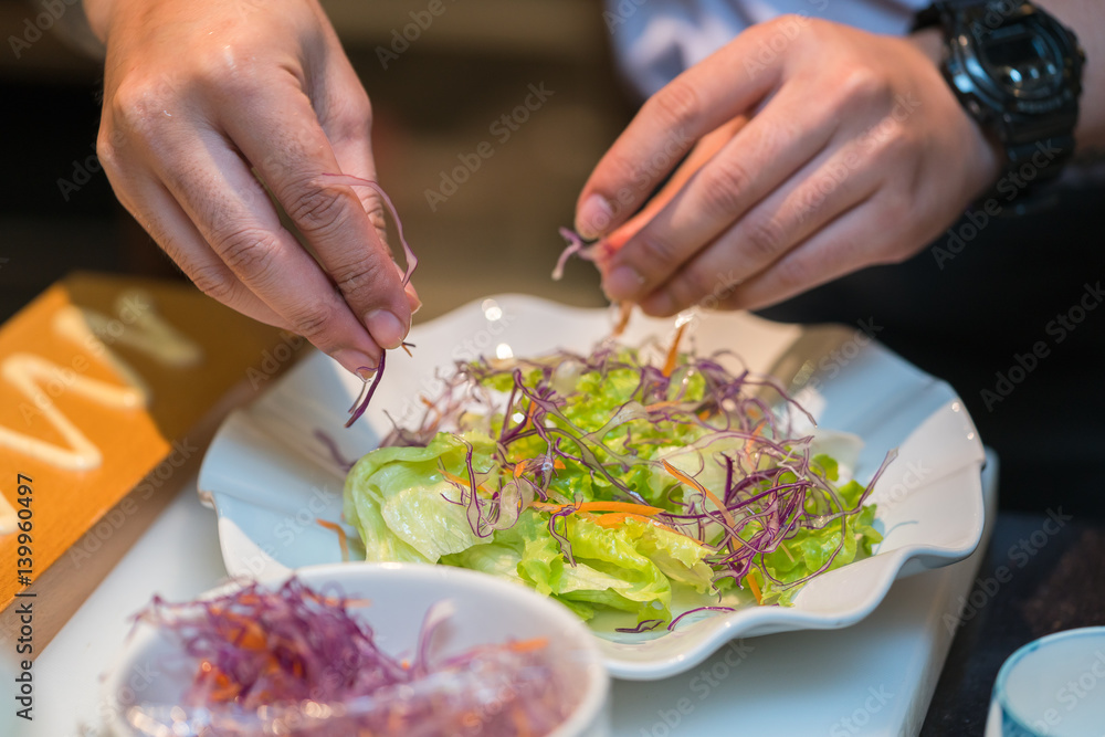 professional chef making salad in the kitchen professional chef making salad in the kitchen