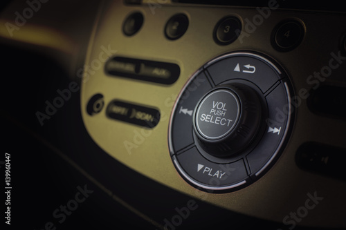 Close up dashboard of a volume control music and radio in car with selective focus.