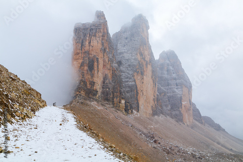 Tre Cime di Lavaredo in beautiful surroundings in the Dolomites at foggy weather (Drei Zinnen)