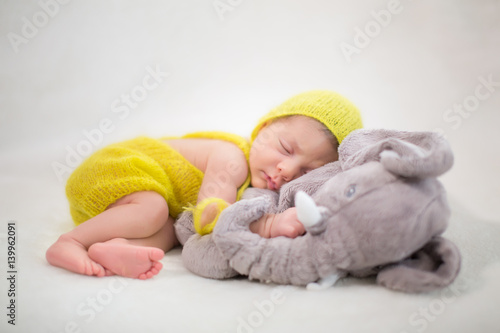 Newborn Baby Girl Wearing a Yellow Hat
