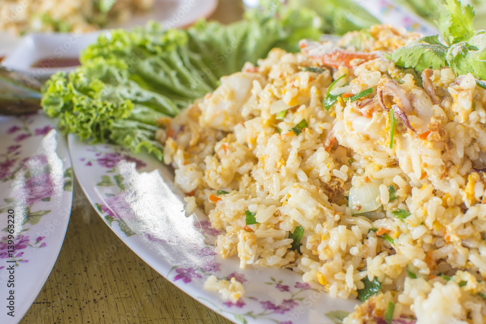 Healthy food. Seafood fried rice on wooden table. thai cuisine with selective focus. Healthy food. Seafood fried rice on wooden table. thai cuisine with selective focus.