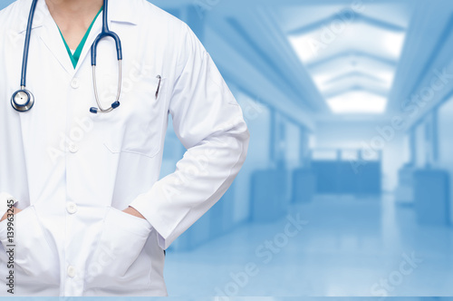 smart doctor with a stethoscope on the hospital blurred background, copy space for text.