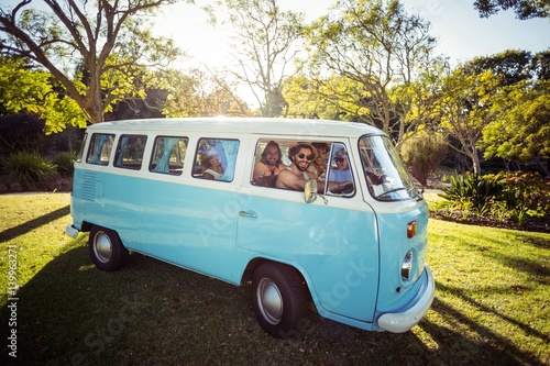 Fototapeta Group of friends travelling in campervan