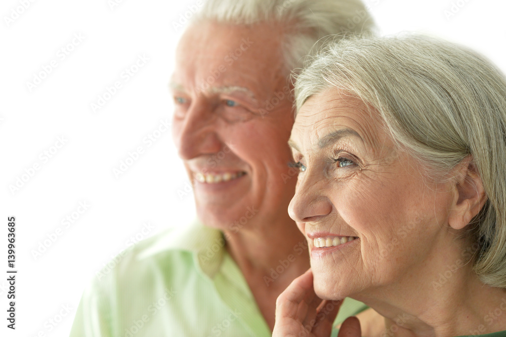 Happy old couple embracing on a white background Happy old couple embracing on a white background