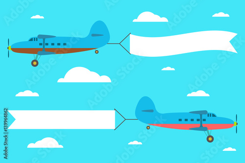 Flying planes with the banner on the background of clouds.