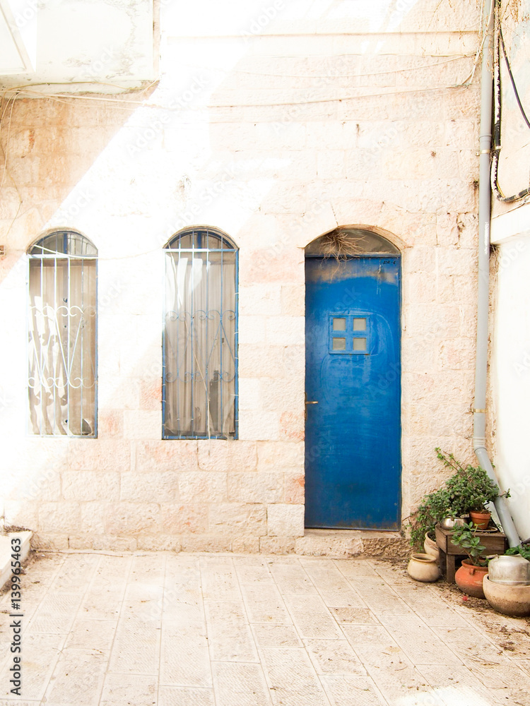 Fototapeta premium Blue Door in White Stone Building