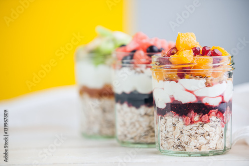 Oatmeal with fruit and cereals in a glass jar